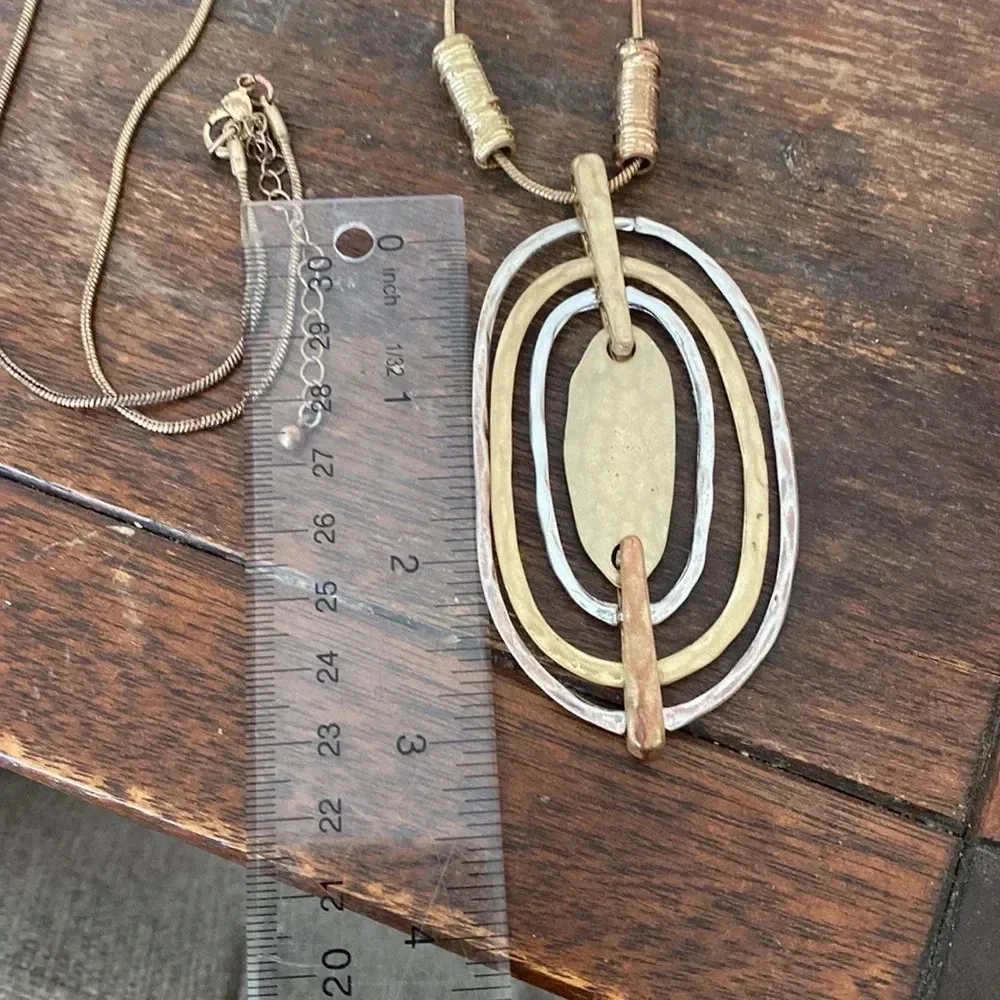 Statement gold and silver tone pendant necklace